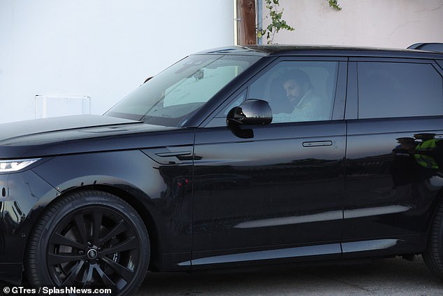 Luxury: The former central defender drove a glossy black Range Rover with complementary black interior and alloys.