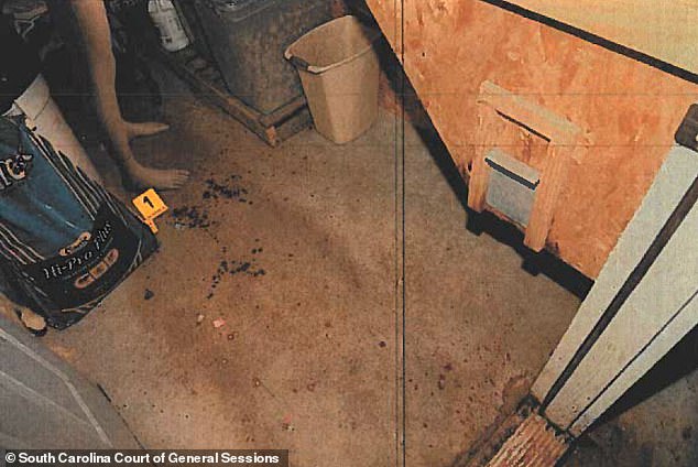 A crime scene photo showing what appears to be blood drops on the floor, a mannequin, and an evidence marker in the feeding room where Paul was fatally shot.