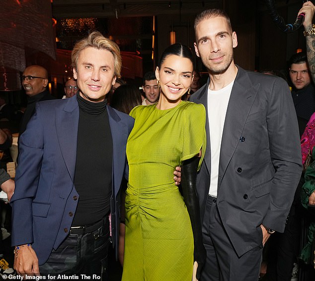 Stylish additions: The 818 Tequila founder slipped on a pair of black leather over-the-knee boots to match the color and style of the gloves.  Seen with Jonathan Cheban, left, and Simon Huck, right