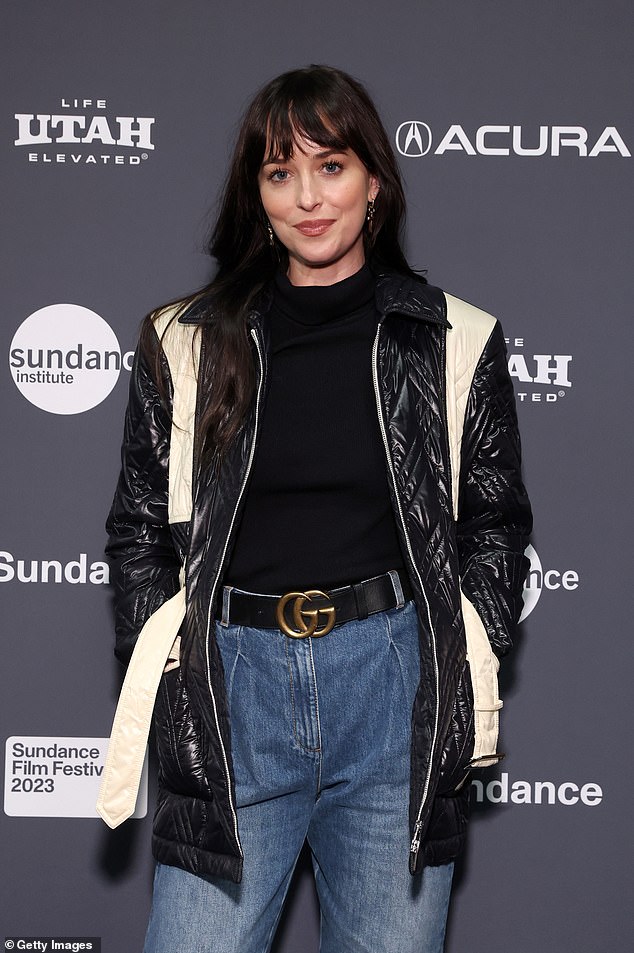 Casual: Johnson, 33, opted to keep it casual and cool in baggy, pleated blue jeans, a black and white patterned jacket over a black crop top, and black boots