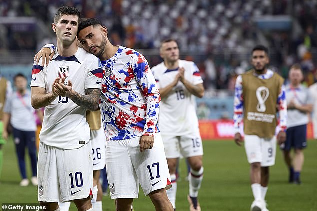 Christian Pulisic of the United States with Cristian Roldan of the United States react after being eliminated from the World Cup by the Netherlands in the round of 16