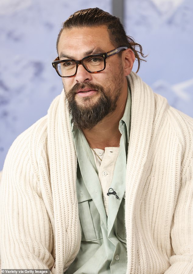 Casual: The 43-year-old Aquaman star also wore a pair of transitional sunglasses and several rings  He had a purple water bottle and a brown film camera in hand.