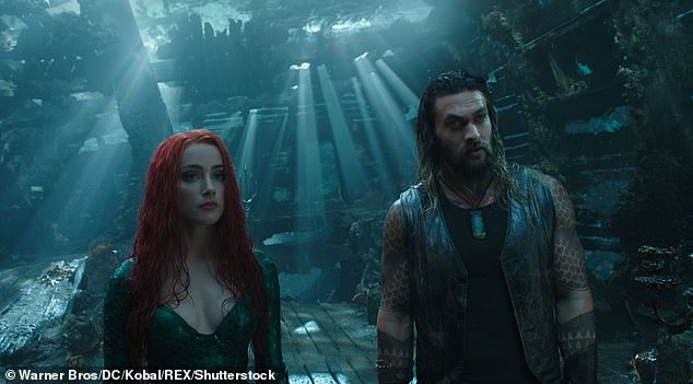 Nonstop: 'I will always be Aquaman.  There's no one to go in there and take shit.  There may be some other characters, too.  I can also play other things';  Pictured in a frame with Amber Heard