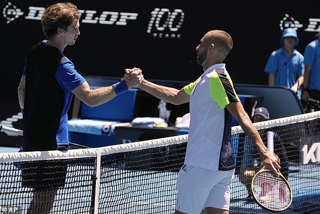 Rublev and Evans shake hands in the net after the contest that the Russian won comfortably in the end