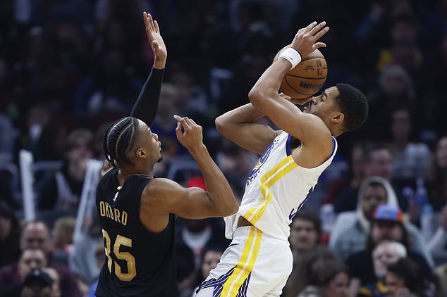 Warriors guard Jordan Poole shoots at Cleveland Cavaliers forward Isaac Okoro (35)