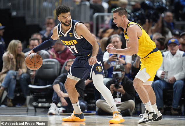 Nuggets guard Jamal Murray, left, looks to pass the ball as Indiana Pacers guard TJ McConnell.