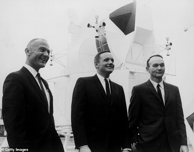 Aldrin, Neil Armstrong and Michael Collins pose in front of a full-scale model of the lunar module that will be carried by their spacecraft.