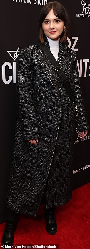 So many stars: Emilia Jones, who plays Alysia Abbott in the picture, was dressed in a charcoal checked long coat that was elegantly contrasted by a white faux turtleneck.