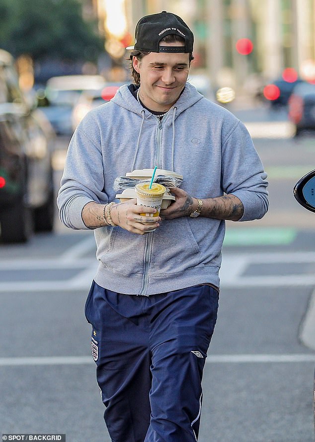 Out for the day: The 23-year-old budding chef decided not to cook anything for himself as he left the store with two takeout boxes, plastic forks and the refreshing drink