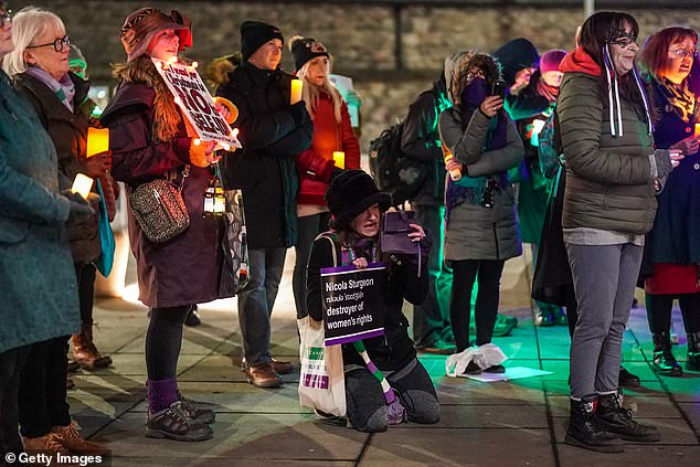 Protesters are seen during a candlelight vigil for what they believe is a loss of women's rights in Scotland.