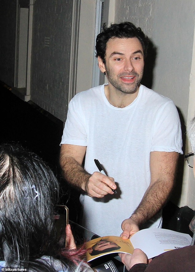 Eager fans: She was followed by her co-star Aidan Turner, 39, who kept it casual in a white T-shirt, black sweatpants and a pair of white sneakers.