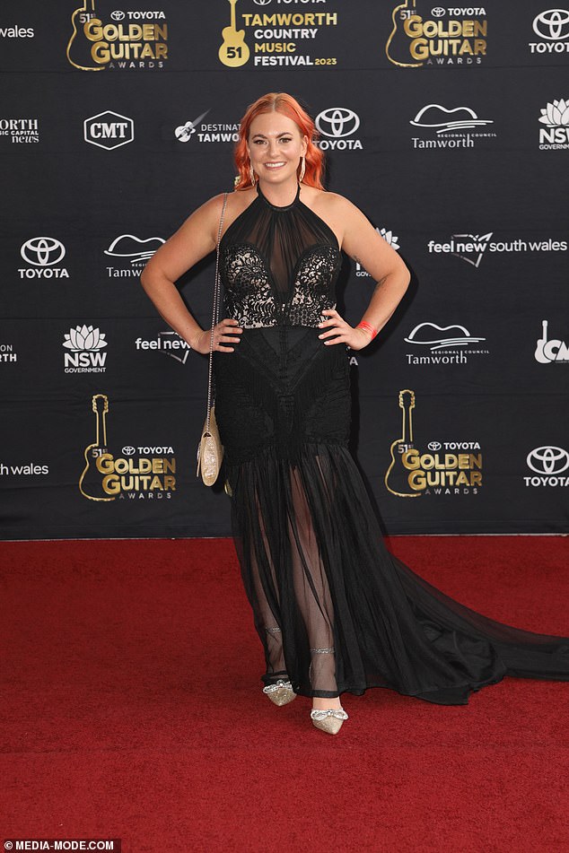 Singer Taylor Moss (pictured) looked glamorous in a sheer black dress with lace details on the bust and a thigh-high slit.