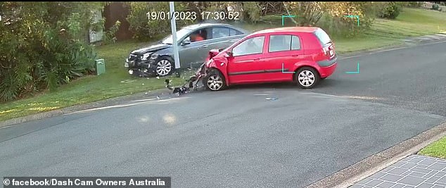 The unsuspecting car was propelled into the middle of the road with debris from its front end thrown into the air (pictured)