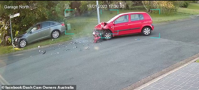 It wasn't over yet as the car took out a street sign (pictured) leaving the red car in shambles.