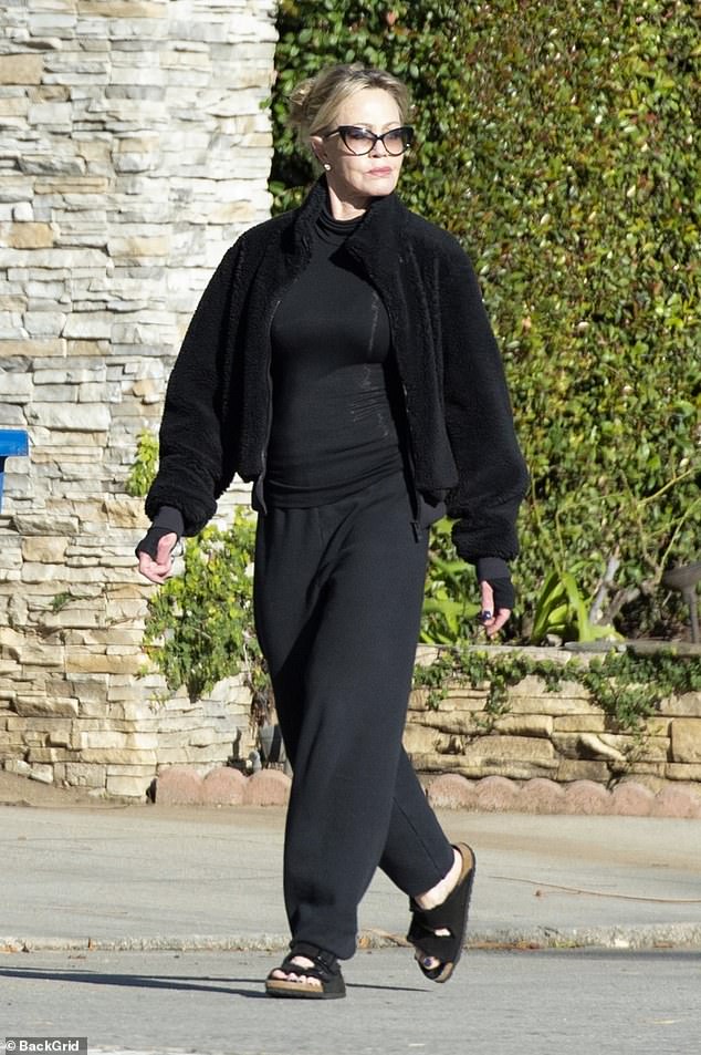 Elegant: Stepping out for a solo stroll, the actress, 65, cut a casual figure in an all-black ensemble and sandals