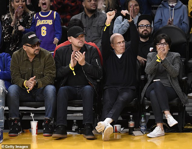 Front row: The 48-year-old Oscar-winning actor appeared in high spirits as he sat on the sidelines with friends to watch the team take on the Memphis Grizzlies.