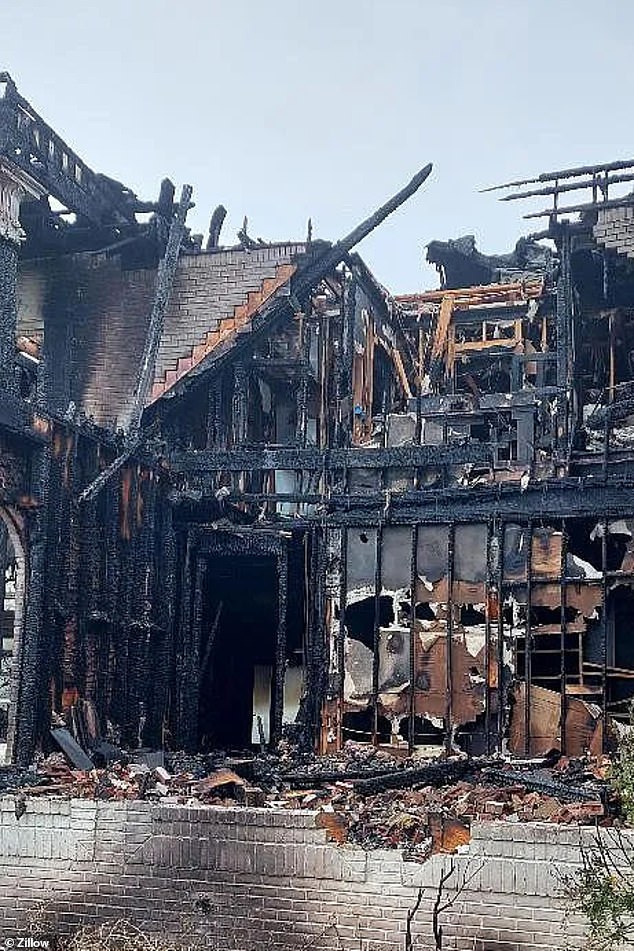 The side of the house has burned to the ground, but the structure on a small portion of the roof is still standing.