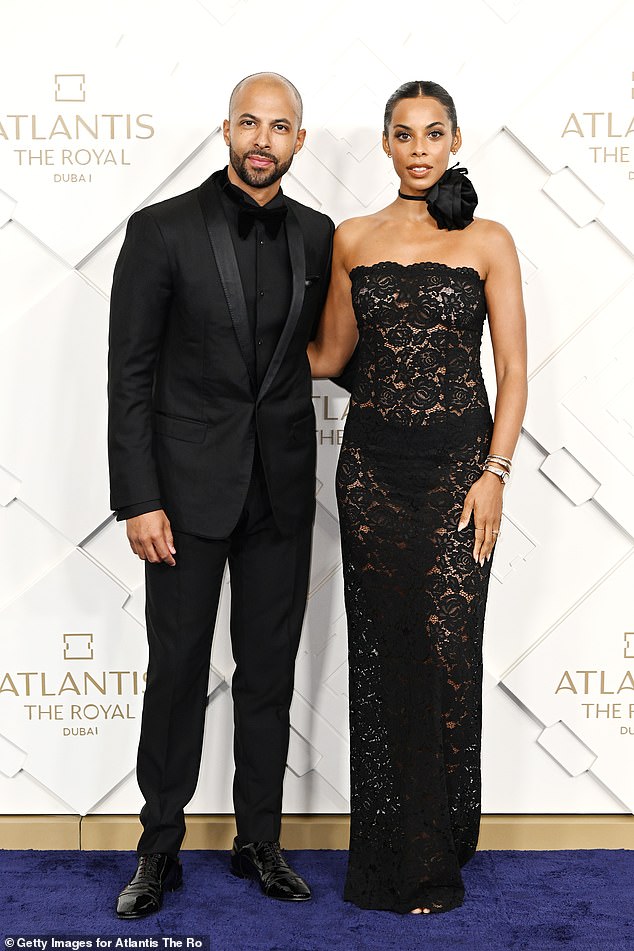 Glam: Also in attendance was Rochelle, 33, who showed off her incredible figure in a strapless, sheer black lace dress while posing with her husband Marvin.