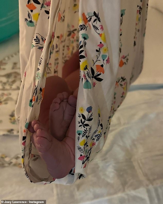 Tiny Feet: The third shot showed a close-up of the baby's feet as she was being lifted up on a blanket.