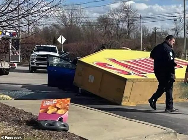 The sign fell amid strong winds in Elizabethtown, Kentucky, on Thursday, and emergency services rushed to the scene to remove the victims.