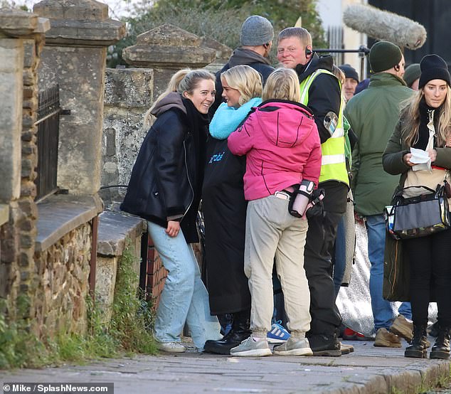 Chilly: The former Coronation Street star was seen being comforted by crew members while bundled up in a big black coat between takes.