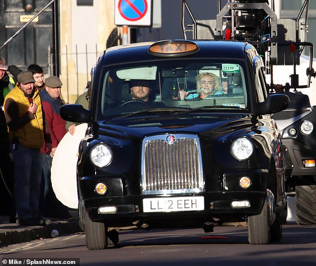 Scene: The actress was seen in the back of a black cab for part of the scene before chatting with crew members between takes.