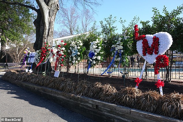 Flowers have been placed on the property, including an LMP heart.