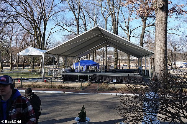 A public service stage has been built on the grass with a podium.  Hundreds of seats have been arranged around it and screens have been placed around the burial site.