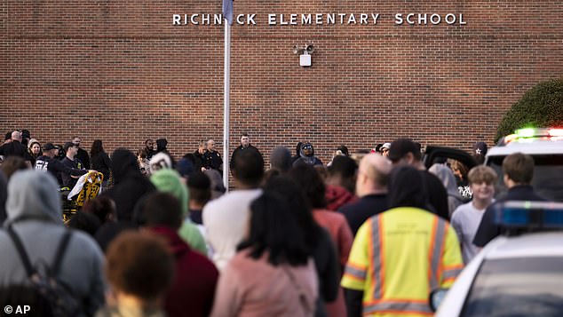 Students and police gather outside Richneck Elementary School after a shooting, Friday, January 6.