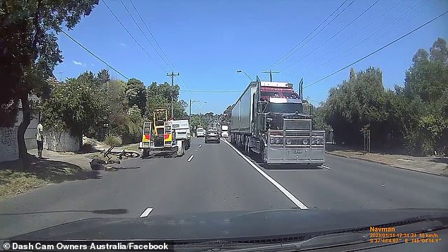 The vehicle then pulls back into the left lane too soon when the end of its trailer engages the bike.