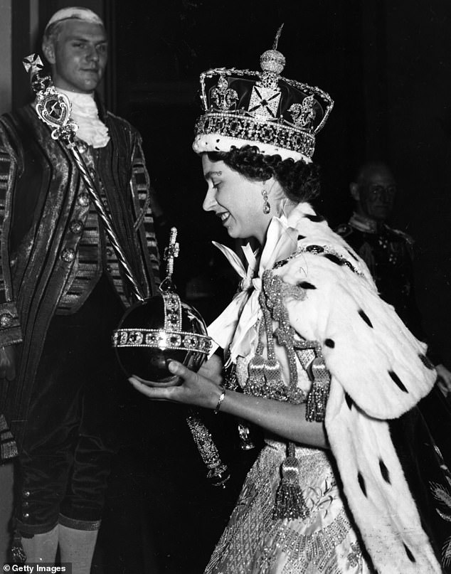 Queen Elizabeth II pictured at her coronation in 1953 holding the Orb and Scepter while wearing the imperial state crown