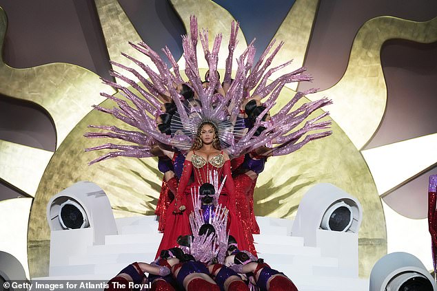 Regal: In another look, Beyonce donned a bright red dress with matching gloves and a gold headpiece.