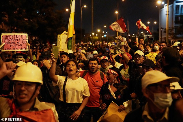 Demonstrators wave Peruvian flags amid anti-government protests following the ouster of former Peruvian President Pedro Castillo, in Lima.