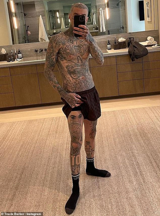 Unmistakable: The Blink-182 drummer, 47, posed for an Instagram snap in which he lifted one of the hems of his boxer briefs to reveal body art scribbled on his right thigh