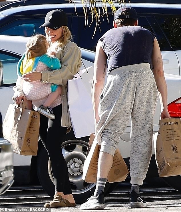 Doting mom: The 34-year-old carried her daughter Mae in a baby carrier on her chest as she stepped out with her husband, musician Matthew Koma, 35.