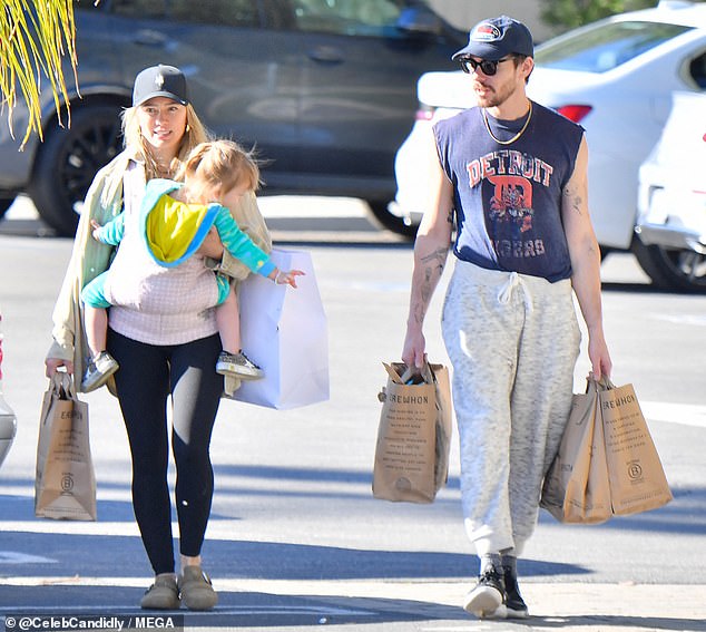 Casual Attire: Matthew kept his errand outfit simple, rocking a pair of light gray joggers, a blue t-shirt with cut-off sleeves, black sneakers, and a navy baseball cap.