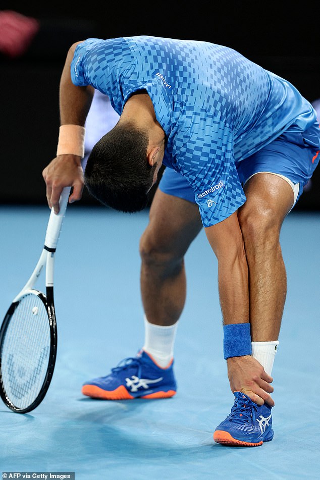 Novak Djokovic reaches for his ankle during his win over Grigor Dimitrov.  The Serb has been forced to use multiple injury time-outs during the tournament.