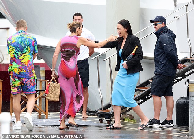 The couple were seen covering themselves with an umbrella as they made their way to the superyacht.