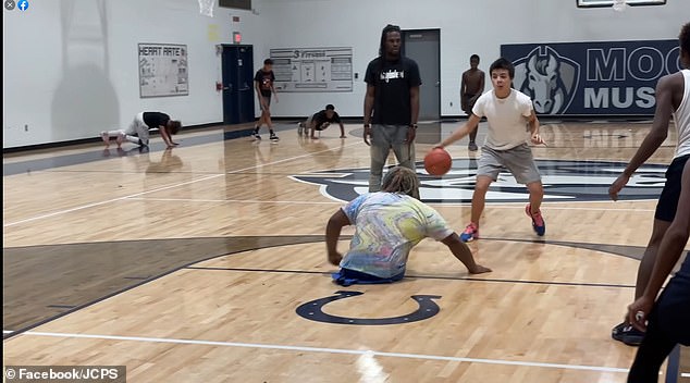 Johnson is seen playing on the courts at Louisville High School.