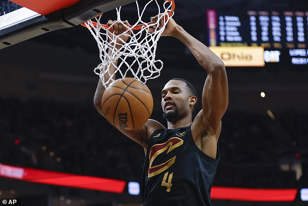 Mobley dunks against the Milwaukee Bucks during the second half of an NBA basketball game.