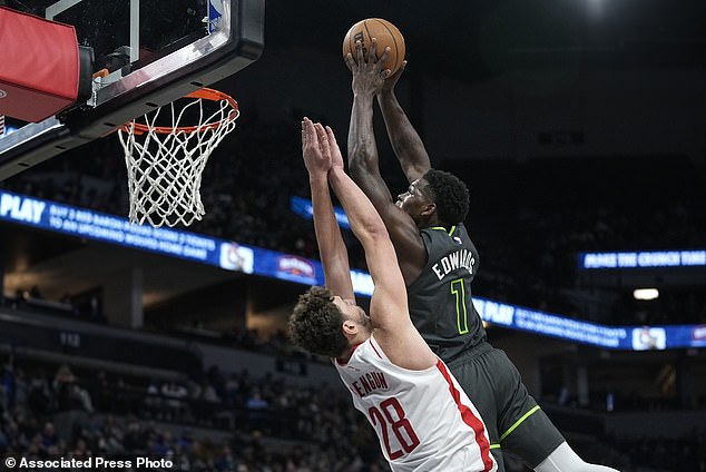 Timberwolves guard Anthony Edwards (1) dunks against Rockets center Alperen Sengun (28)