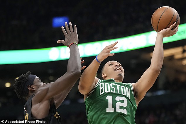 Celtics forward Grant Williams (12) goes up to the basket as Raptors forward Pascal Siakam