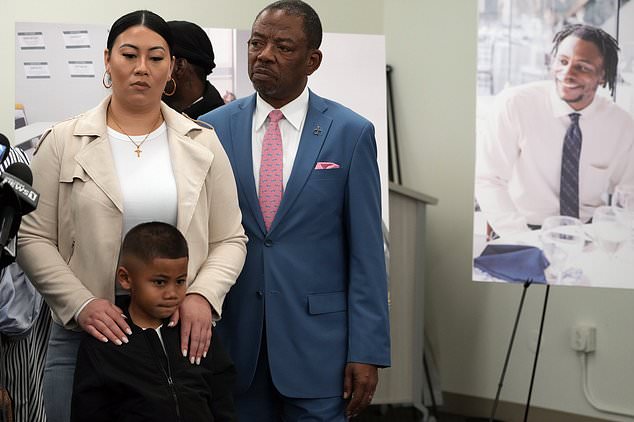 Attorney Carl Douglas, right, holds a press conference with Gabrielle Hansel, guardian of five-year-old Syncere Kai Anderson, to announce the filing of a $50 million damages lawsuit.