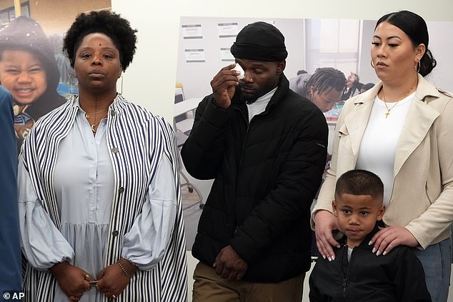 Patrisse Cullors, left, co-founder of the Black Lives Matter movement, listens as Gabrielle Hansell, mother of five-year-old Syncere Kai Anderson, right, announce a lawsuit.