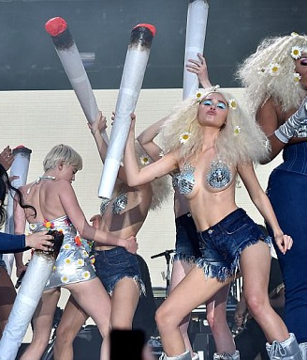 The resurfaced images show a woman resembling Brooks appearing onstage with Miley at Capital FM's Summertime Ball in London in June 2014, where the US pop star performed hits from her album, Bangerz.  The woman is in the photo on the right.