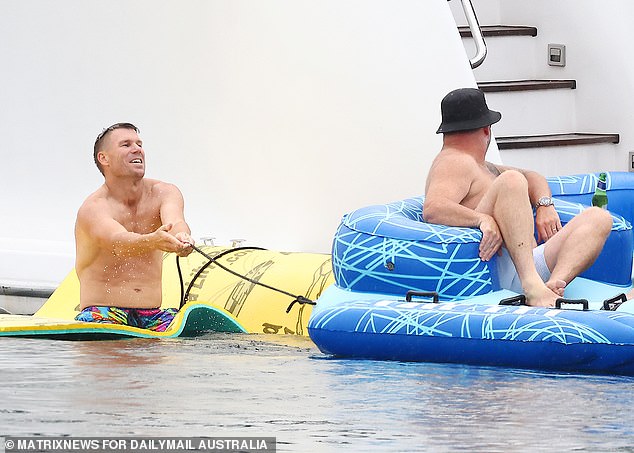 He eventually stripped down to his shorts before jumping into the water on a large floating mat of water.