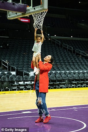 Hamby lifts his daughter to the hoop after a game at Staples Center in 2019