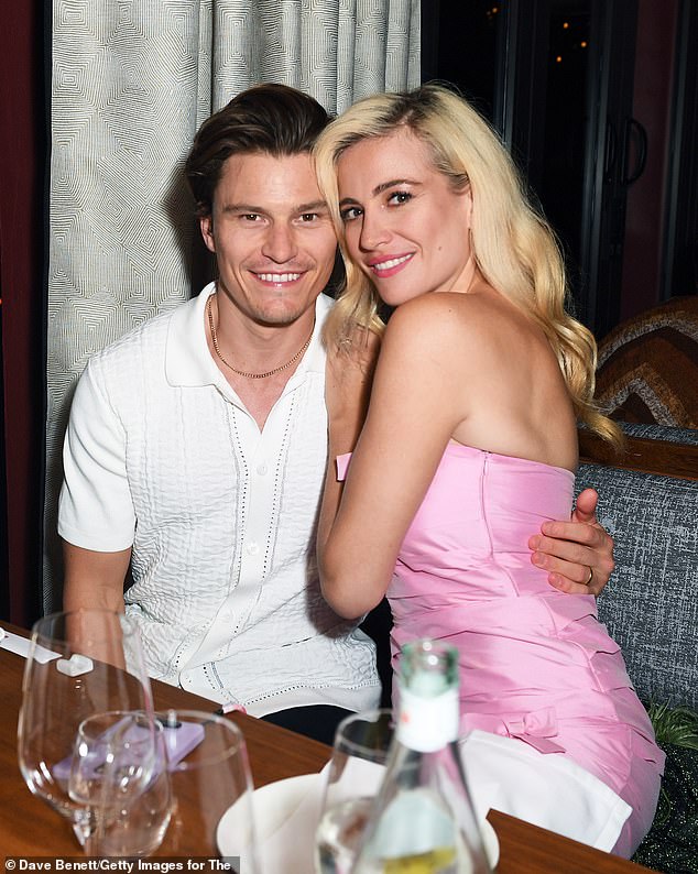 Happy couple: Her husband Oliver, who was also at her side, donned a smart-yet-casual white polo shirt that featured an all-over textured print for the lavish night ahead