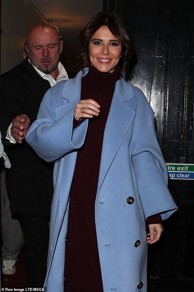 Safe: Cheryl was clearly pleased with her performance, as she couldn't stop smiling while she was outside and where her security team was escorting her