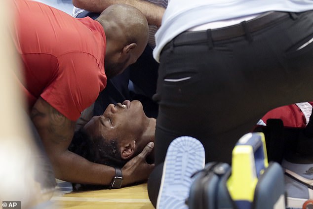 After landing on the court, the sophomore received medical attention from the coaches.